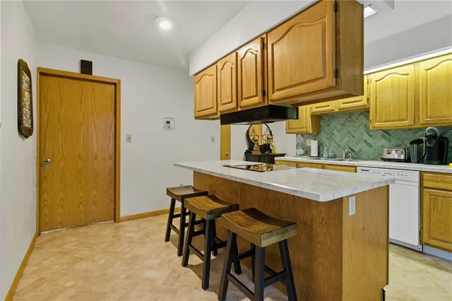 a kitchen with stainless steel appliances granite countertop a sink and cabinets