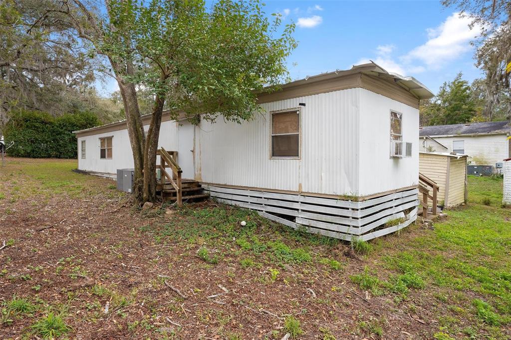 2107 Hialeah Avenue Leesburg, FL 34748 - Photo 5 of 10 a view of a house with a yard and a tree