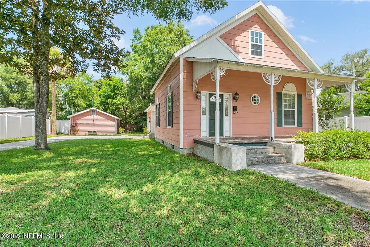 a front view of house with yard and outdoor seating