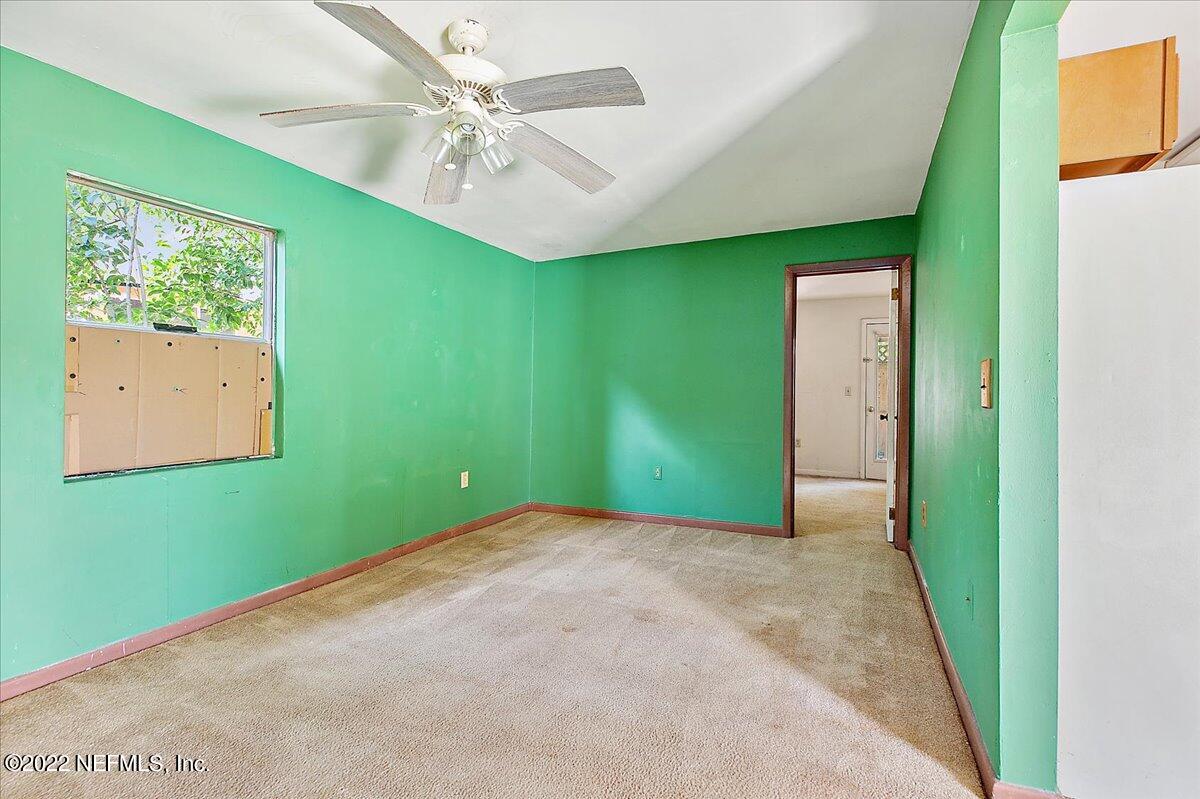 3404 St Augustine Road Jacksonville, FL 32207 - Photo 14 of 16 a view of a big room with a fireplace and a ceiling fan