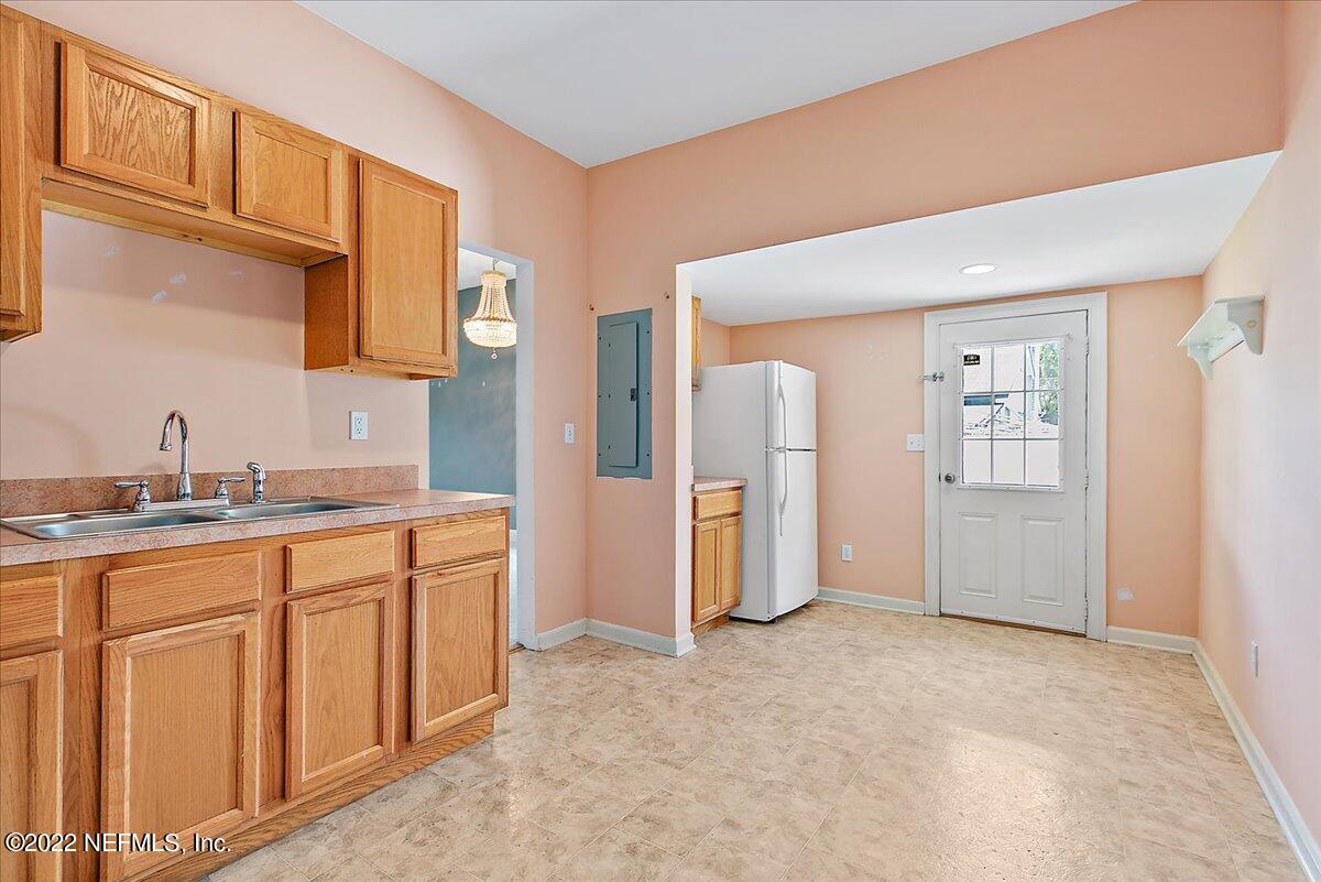 3404 St Augustine Road Jacksonville, FL 32207 - Photo 3 of 16 a spacious bathroom with a granite countertop sink and a mirror