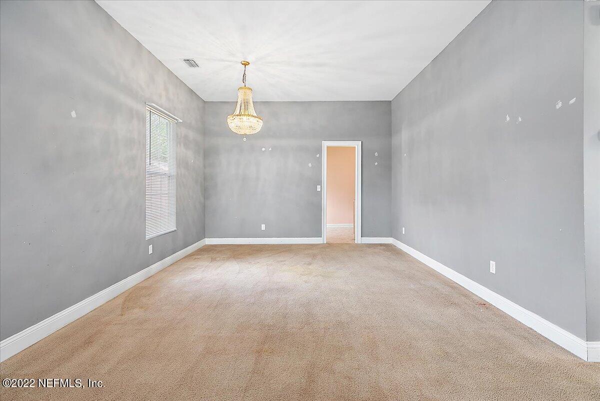 3404 St Augustine Road Jacksonville, FL 32207 - Photo 8 of 16 a view of an empty room with a chandelier fan