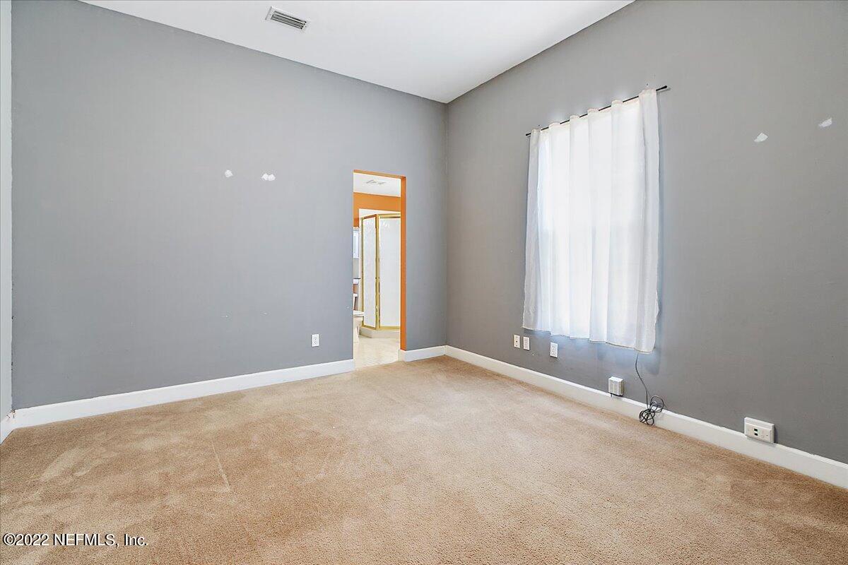 3404 St Augustine Road Jacksonville, FL 32207 - Photo 9 of 16 an empty room with windows and closet