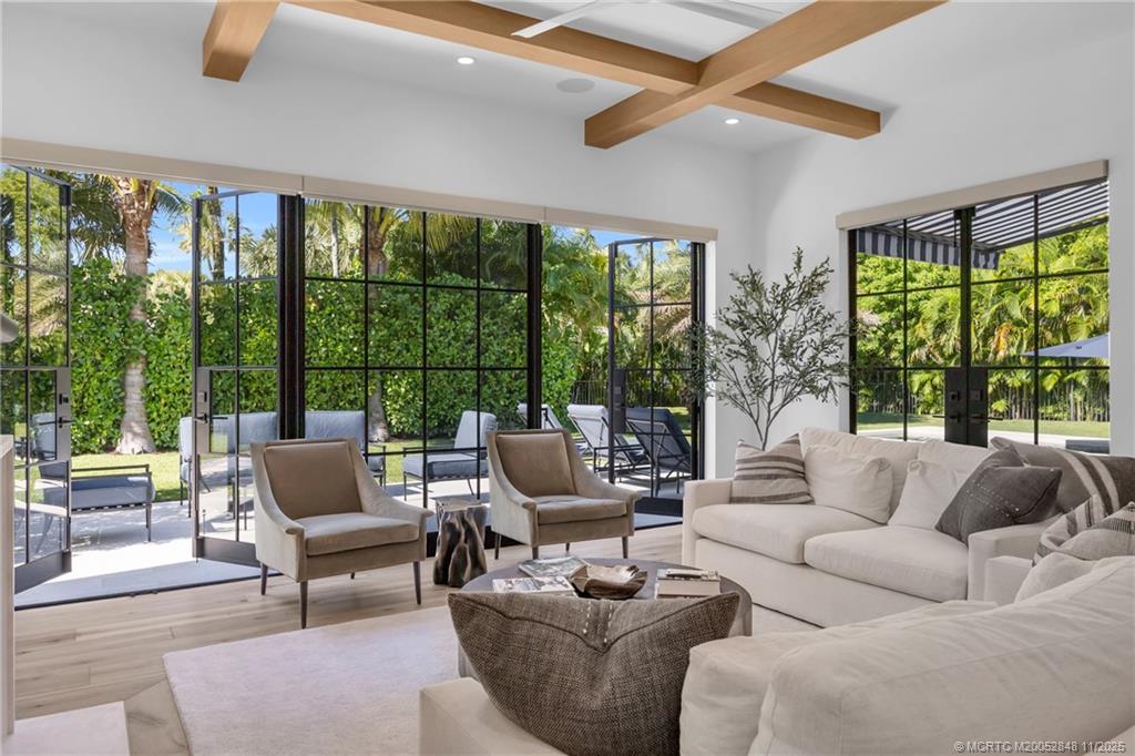 44 South Beach Road Hobe Sound, FL 33455 - Photo 11 of 73 a living room with furniture and a large window