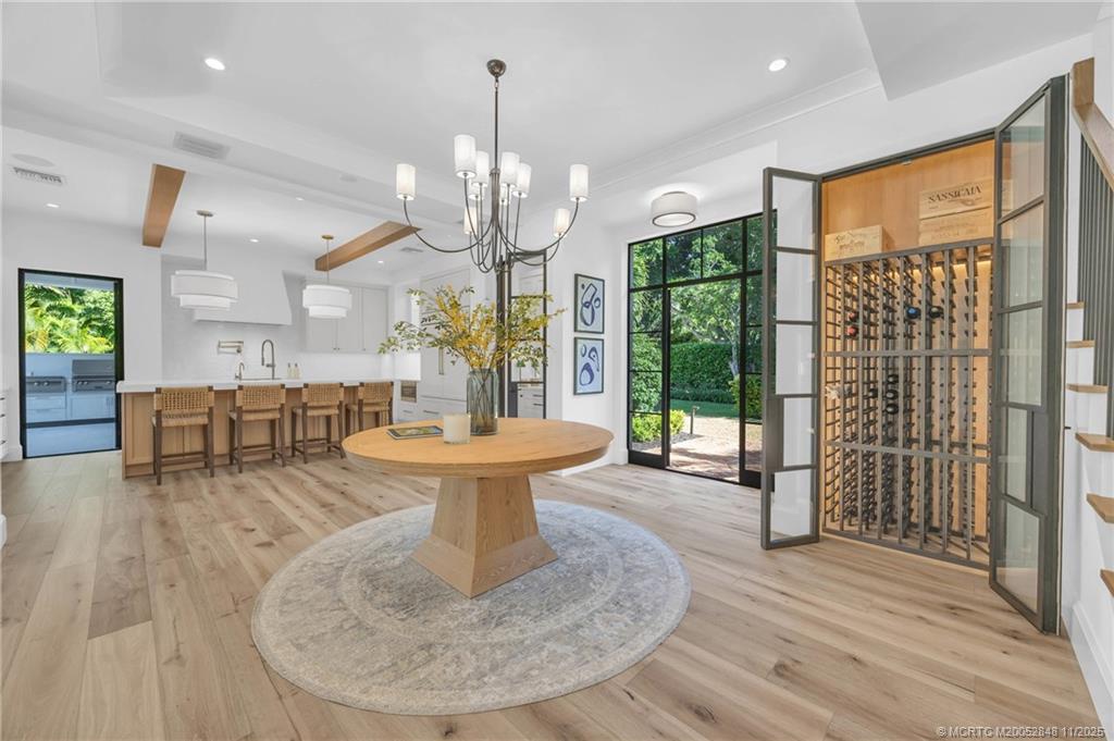 44 South Beach Road Hobe Sound, FL 33455 - Photo 28 of 73 a living room with furniture a chandelier and a wooden floor