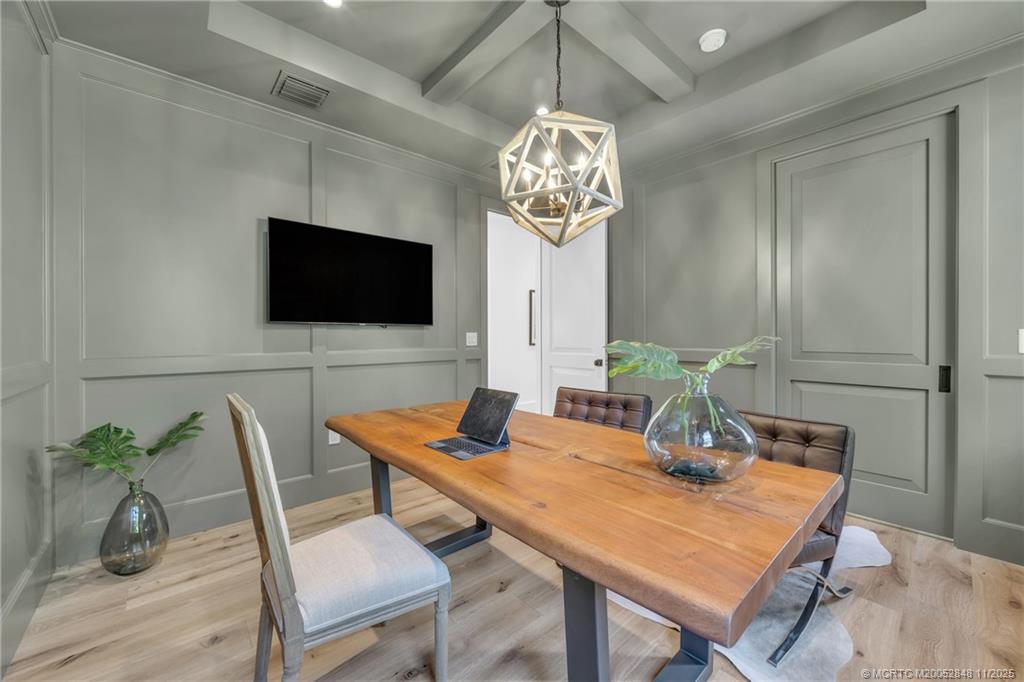 44 South Beach Road Hobe Sound, FL 33455 - Photo 31 of 73 a view of a dining room with furniture wooden floor and chandelier