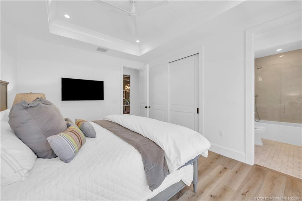 44 South Beach Road Hobe Sound, FL 33455 - Photo 33 of 73 a bedroom with a bed and a flat tv screen on dresser