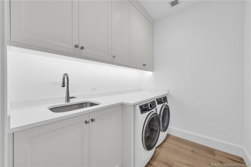 44 South Beach Road Hobe Sound, FL 33455 - Photo 35 of 73 a utility room with sink dryer and washer
