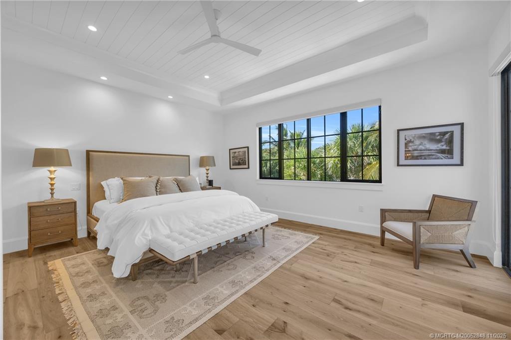 44 South Beach Road Hobe Sound, FL 33455 - Photo 38 of 73 a bedroom with a bed and a chair