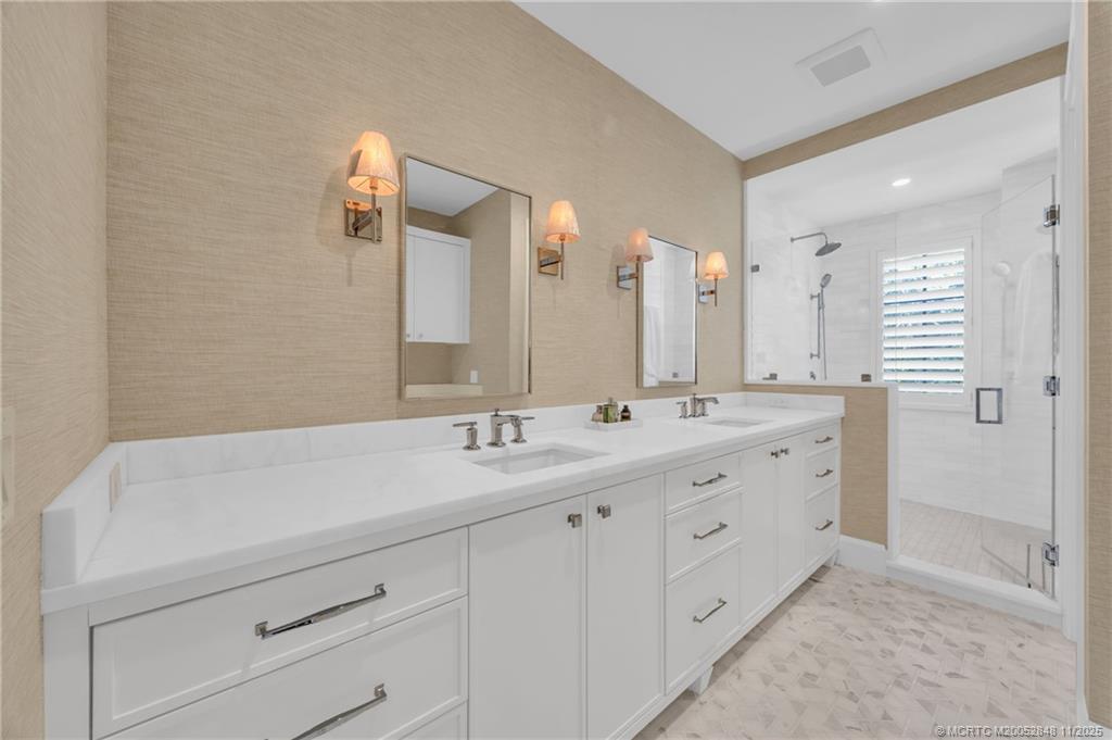 44 South Beach Road Hobe Sound, FL 33455 - Photo 41 of 73 a bathroom with a double vanity sink and mirror