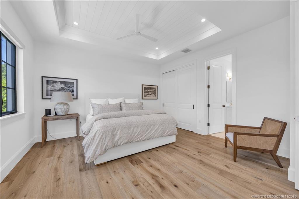 44 South Beach Road Hobe Sound, FL 33455 - Photo 47 of 73 a spacious bedroom with a bed and a table