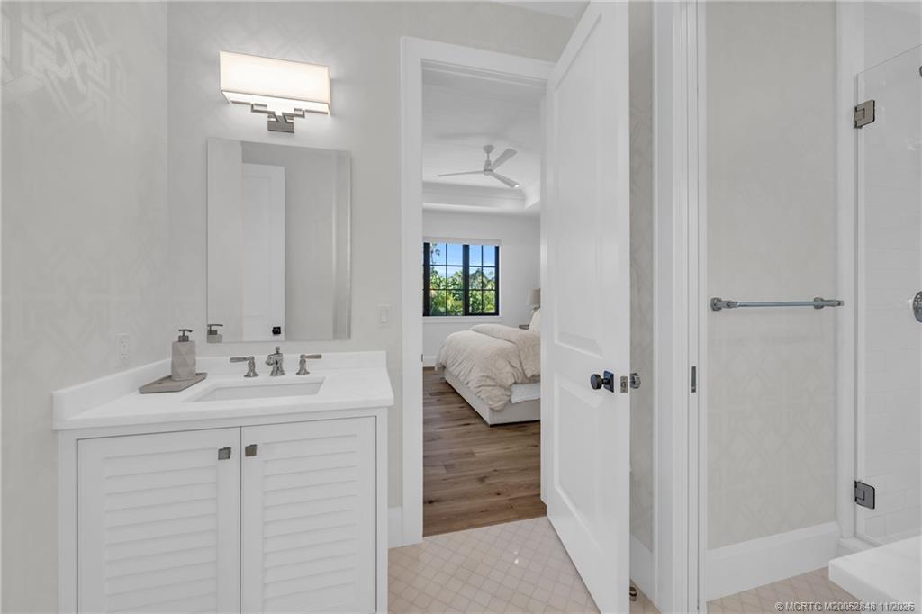 44 South Beach Road Hobe Sound, FL 33455 - Photo 53 of 73 a en suite bathroom with a sink and mirror