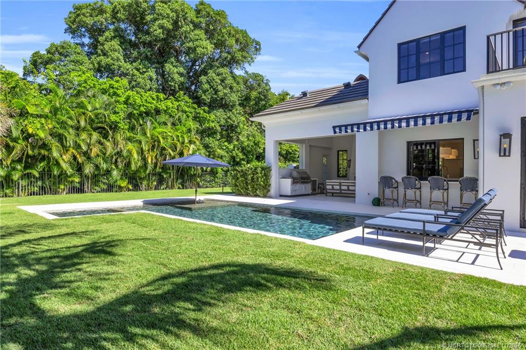 44 South Beach Road Hobe Sound, FL 33455 - Photo 64 of 73 a view of a patio with a table and chairs