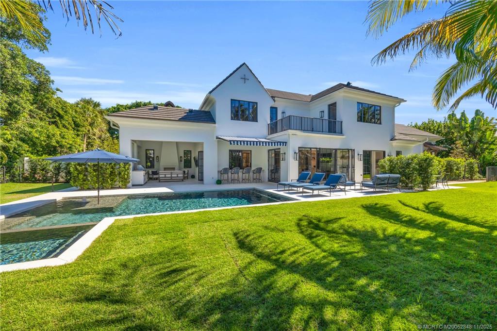 44 South Beach Road Hobe Sound, FL 33455 - Photo 66 of 73 a front view of a house with swimming pool having outdoor seating