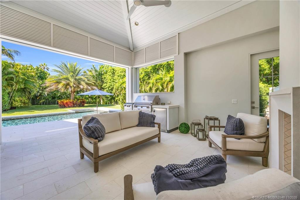 44 South Beach Road Hobe Sound, FL 33455 - Photo 69 of 73 a living room with furniture and a flat screen tv