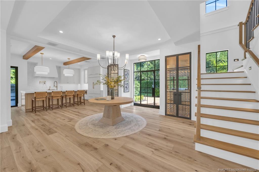 44 South Beach Road Hobe Sound, FL 33455 - Photo 7 of 73 a view of a dining room with furniture a chandelier and wooden floor