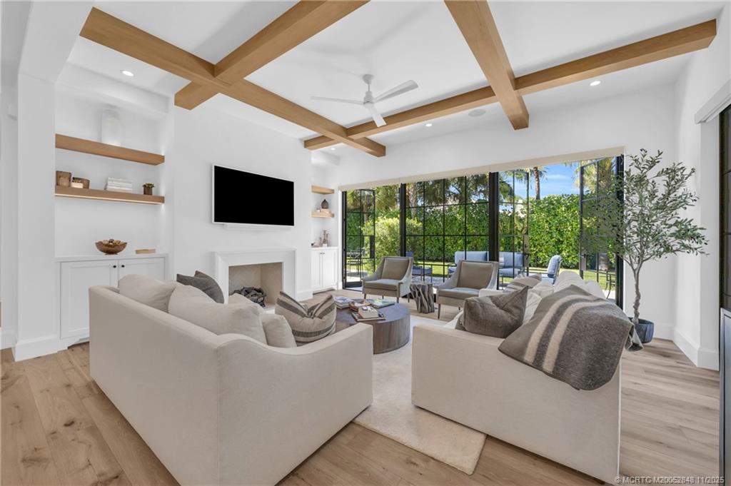 44 South Beach Road Hobe Sound, FL 33455 - Photo 9 of 73 a living room with furniture a large window and a flat screen tv