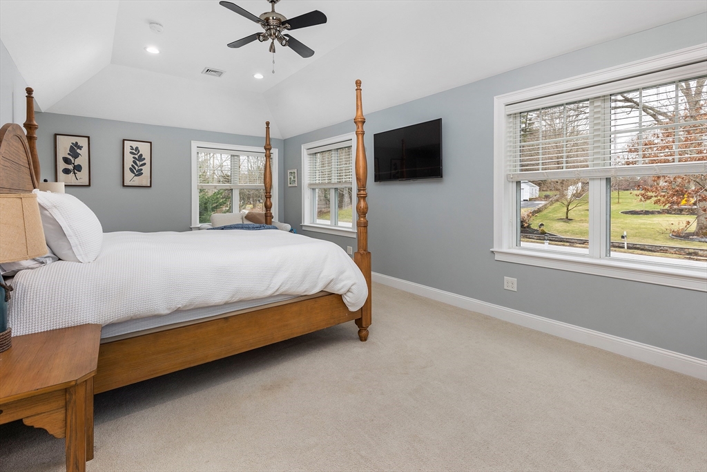732 Center Street Hanover, MA 02339 - Photo 16 of 38 a bedroom with a bed a window and a flat screen tv