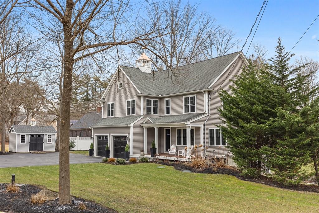 732 Center Street Hanover, MA 02339 - Photo 2 of 38 a front view of a house with a garden and trees