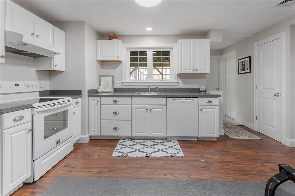 732 Center Street Hanover, MA 02339 - Photo 30 of 38 a kitchen with stainless steel appliances granite countertop a stove a sink and a refrigerator