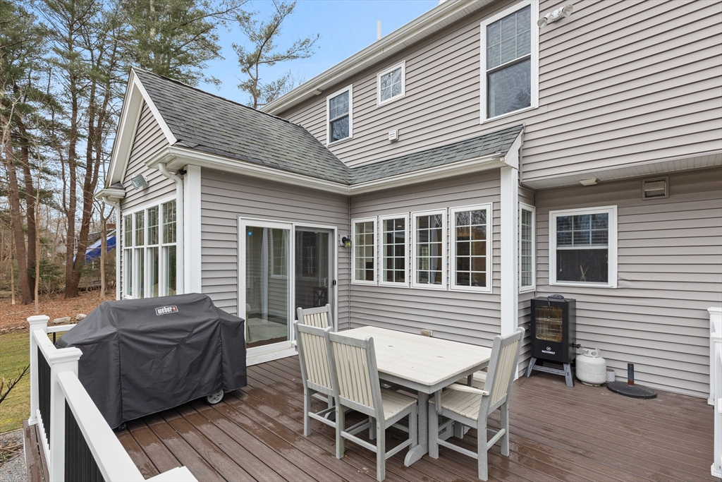 732 Center Street Hanover, MA 02339 - Photo 32 of 38 a view of a house with a barbeque and wooden furniture