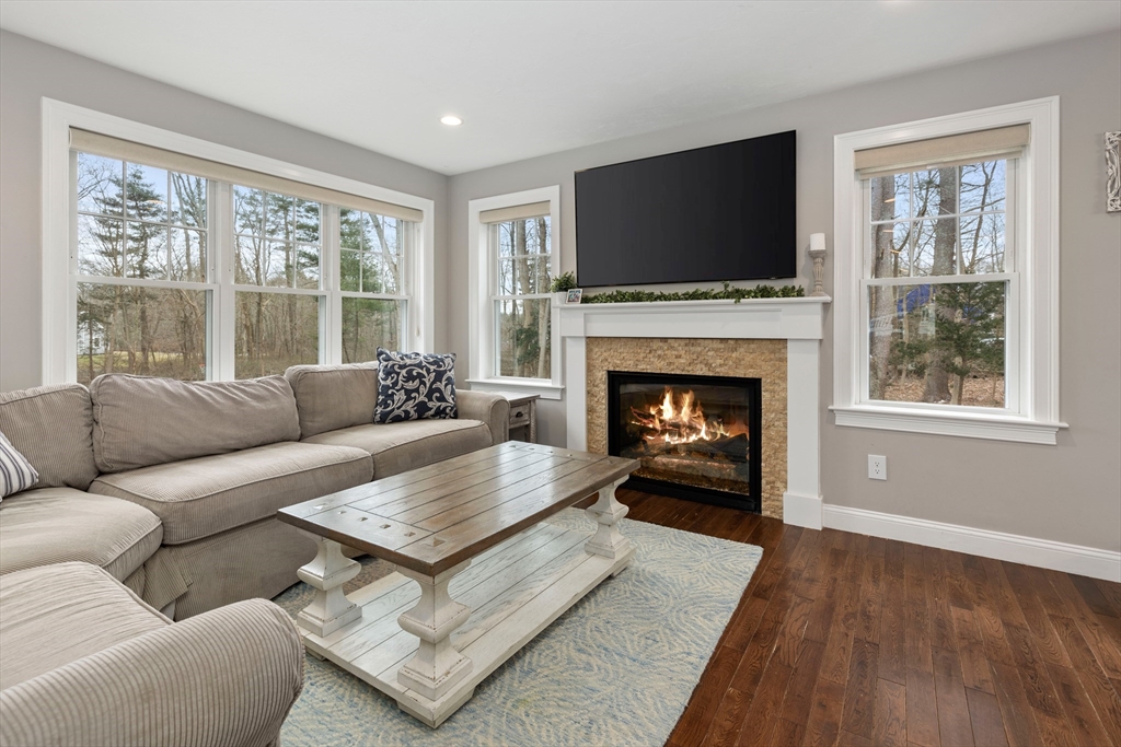 732 Center Street Hanover, MA 02339 - Photo 4 of 38 a living room with furniture a flat screen tv and a fireplace