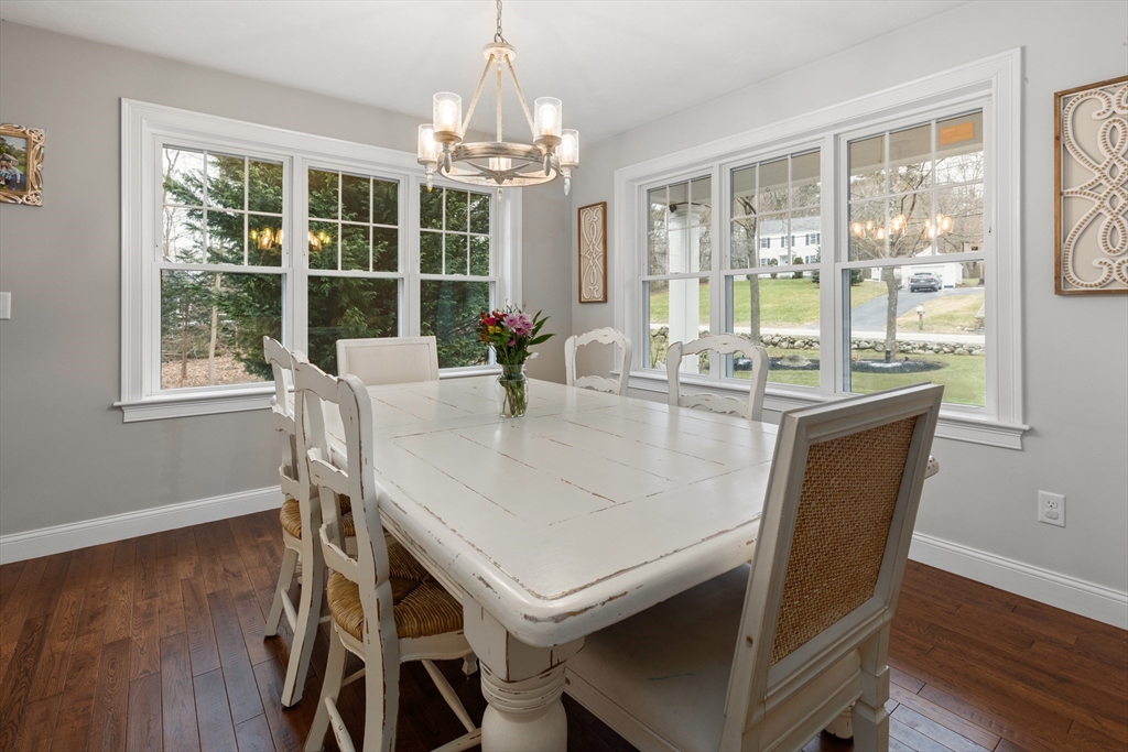 732 Center Street Hanover, MA 02339 - Photo 10 of 38 a dining room with furniture a chandelier and wooden floor