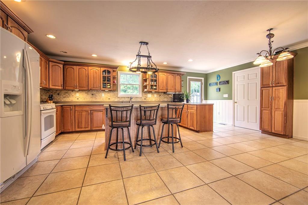 151 Drake Road Bethel Park, PA 15102 - Photo 9 of 25 Spacious eat-in custom kitchen with hickory cabinets and solid surface countertops.