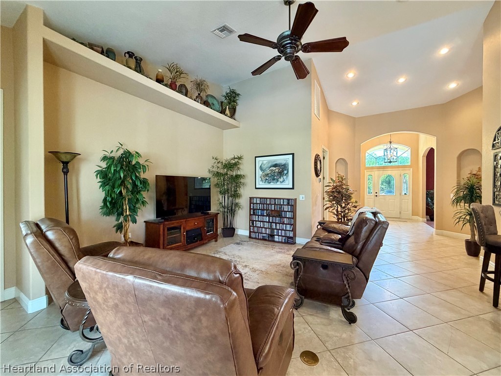 6032 Elm Road Sebring, FL 33875 - Photo 12 of 47 a living room with furniture and a flat screen tv