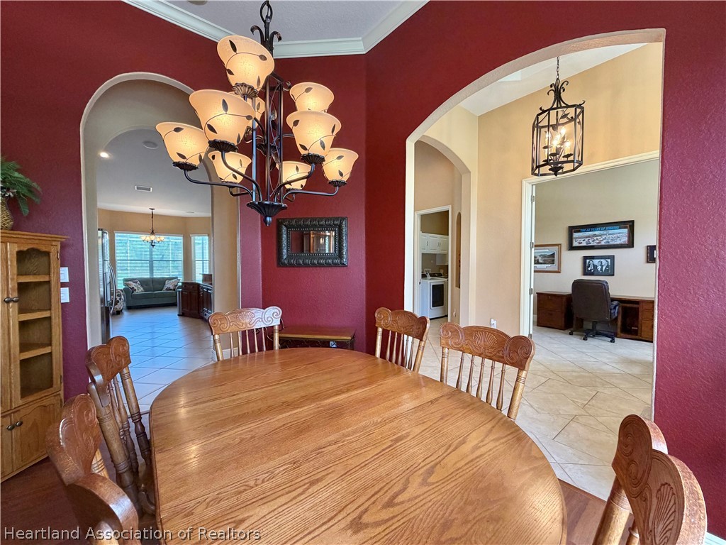 6032 Elm Road Sebring, FL 33875 - Photo 13 of 47 a bedroom with a bed and a chandelier