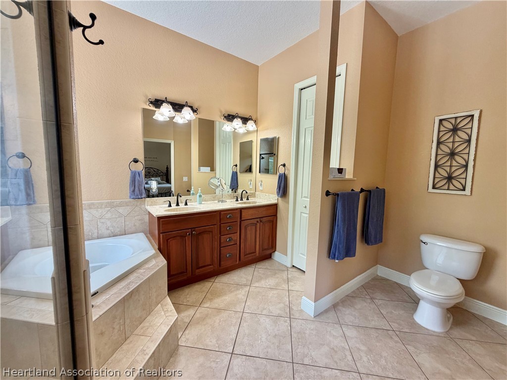 6032 Elm Road Sebring, FL 33875 - Photo 18 of 47 a bathroom with a sink a toilet and shower