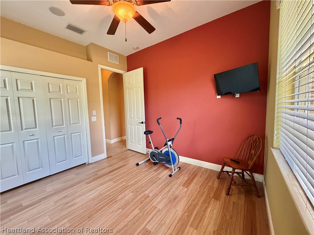 6032 Elm Road Sebring, FL 33875 - Photo 23 of 47 a room with gym equipment and wooden floor