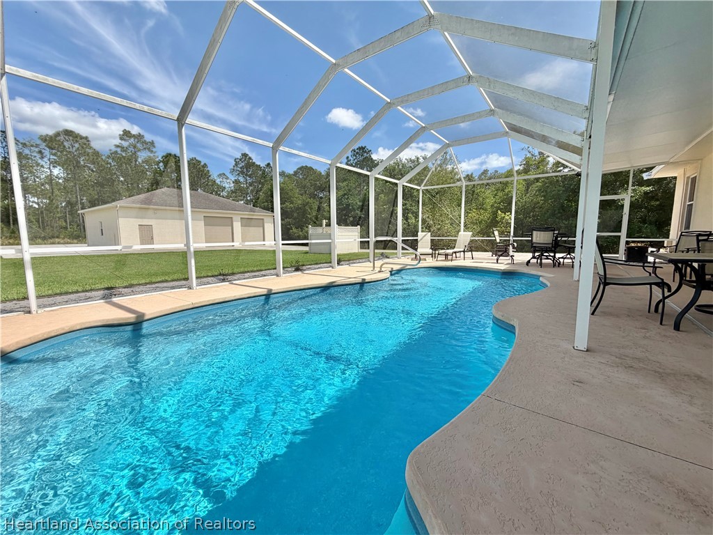 6032 Elm Road Sebring, FL 33875 - Photo 27 of 47 a view of a house with a backyard patio and a backyard