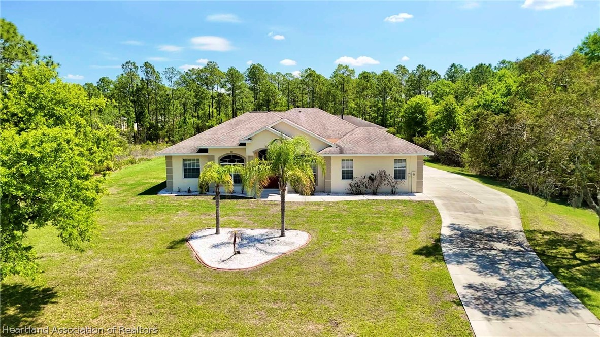 6032 Elm Road Sebring, FL 33875 - Photo 32 of 47 a aerial view of a house with table and chairs with wooden fence