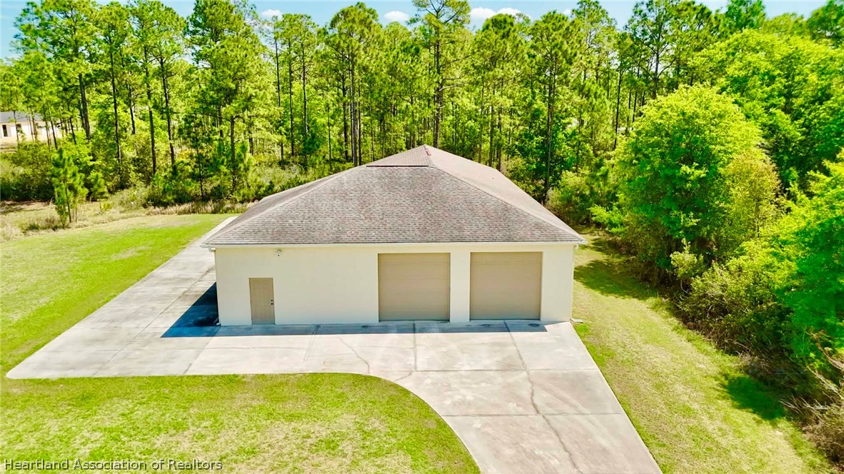 6032 Elm Road Sebring, FL 33875 - Photo 34 of 47 a house view with swimming pool in front of it