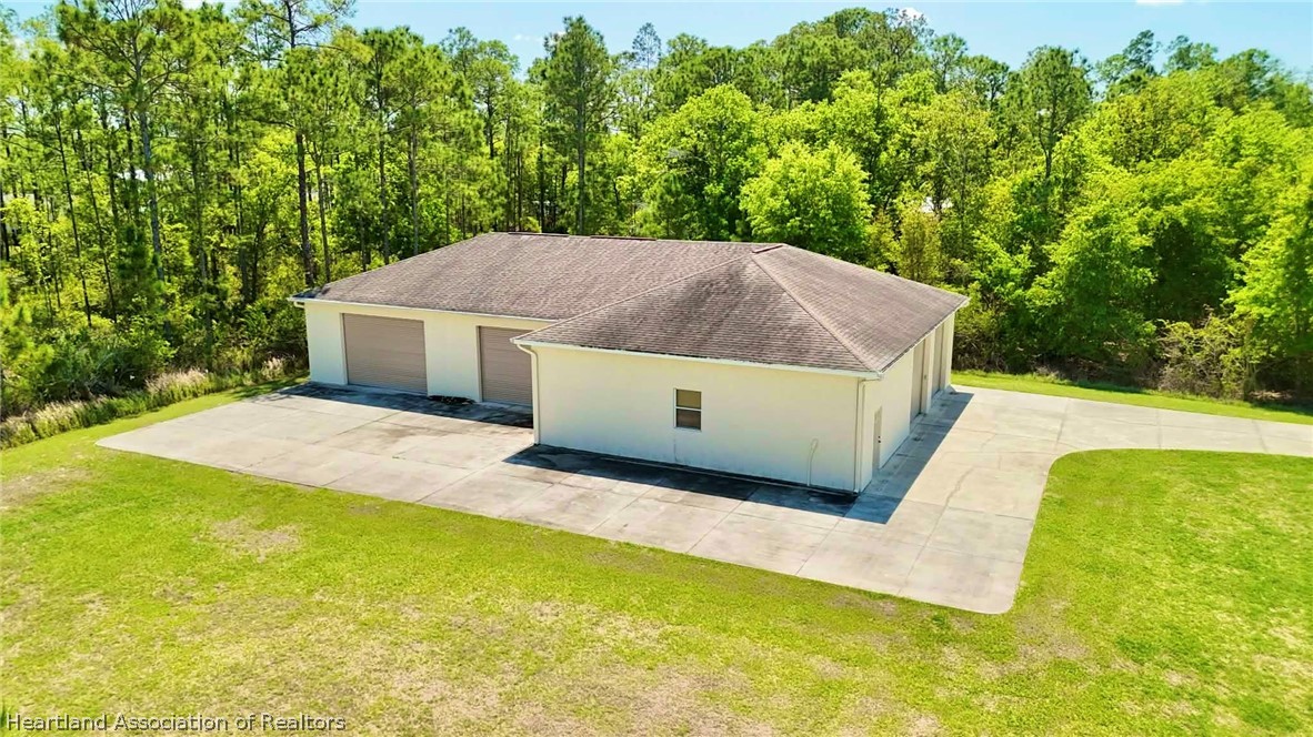 6032 Elm Road Sebring, FL 33875 - Photo 35 of 47 a white house with a large pool