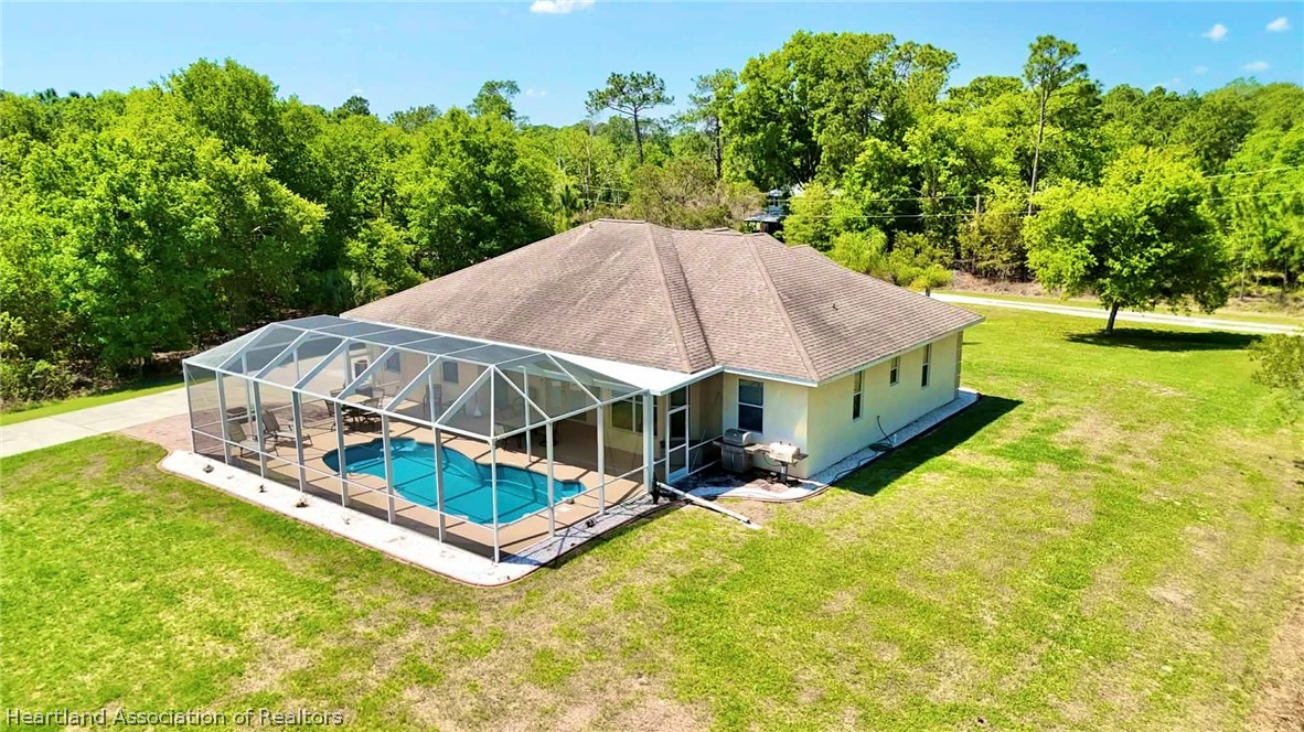 6032 Elm Road Sebring, FL 33875 - Photo 36 of 47 an aerial view of a house with swimming pool and large trees