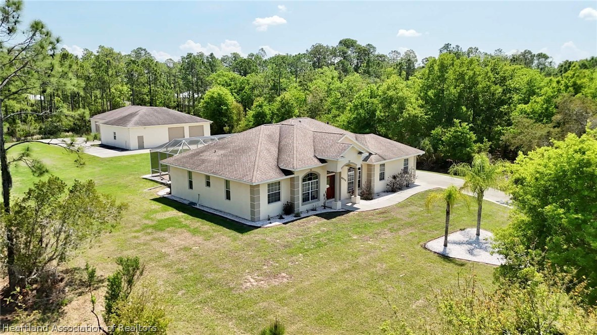 6032 Elm Road Sebring, FL 33875 - Photo 41 of 47 a aerial view of a house with swimming pool and large trees