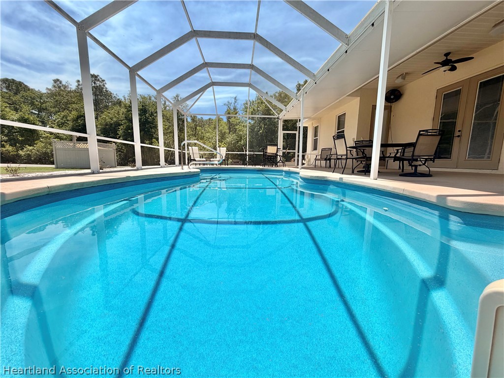6032 Elm Road Sebring, FL 33875 - Photo 46 of 47 a view of a swimming pool with a porch