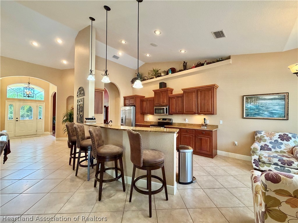 6032 Elm Road Sebring, FL 33875 - Photo 5 of 47 a large kitchen with a table and chairs