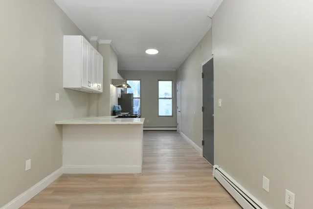 a view of kitchen with wooden floor