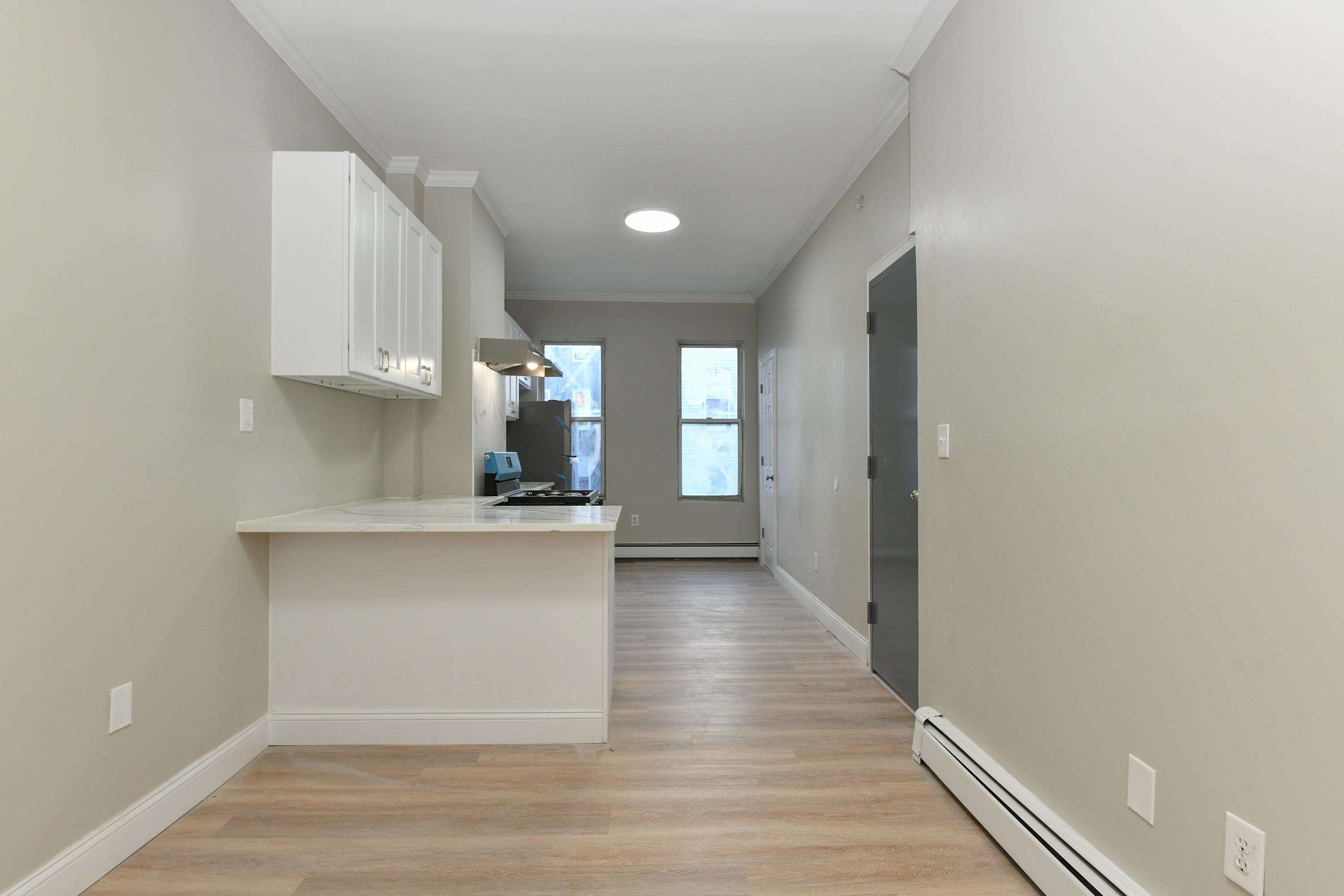 531 28th Street, Unit 2 Union City, NJ 07087 - Photo 16 of 25 a view of kitchen with wooden floor