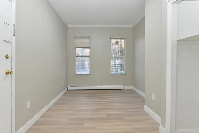 a view of room with window and hardwood floor