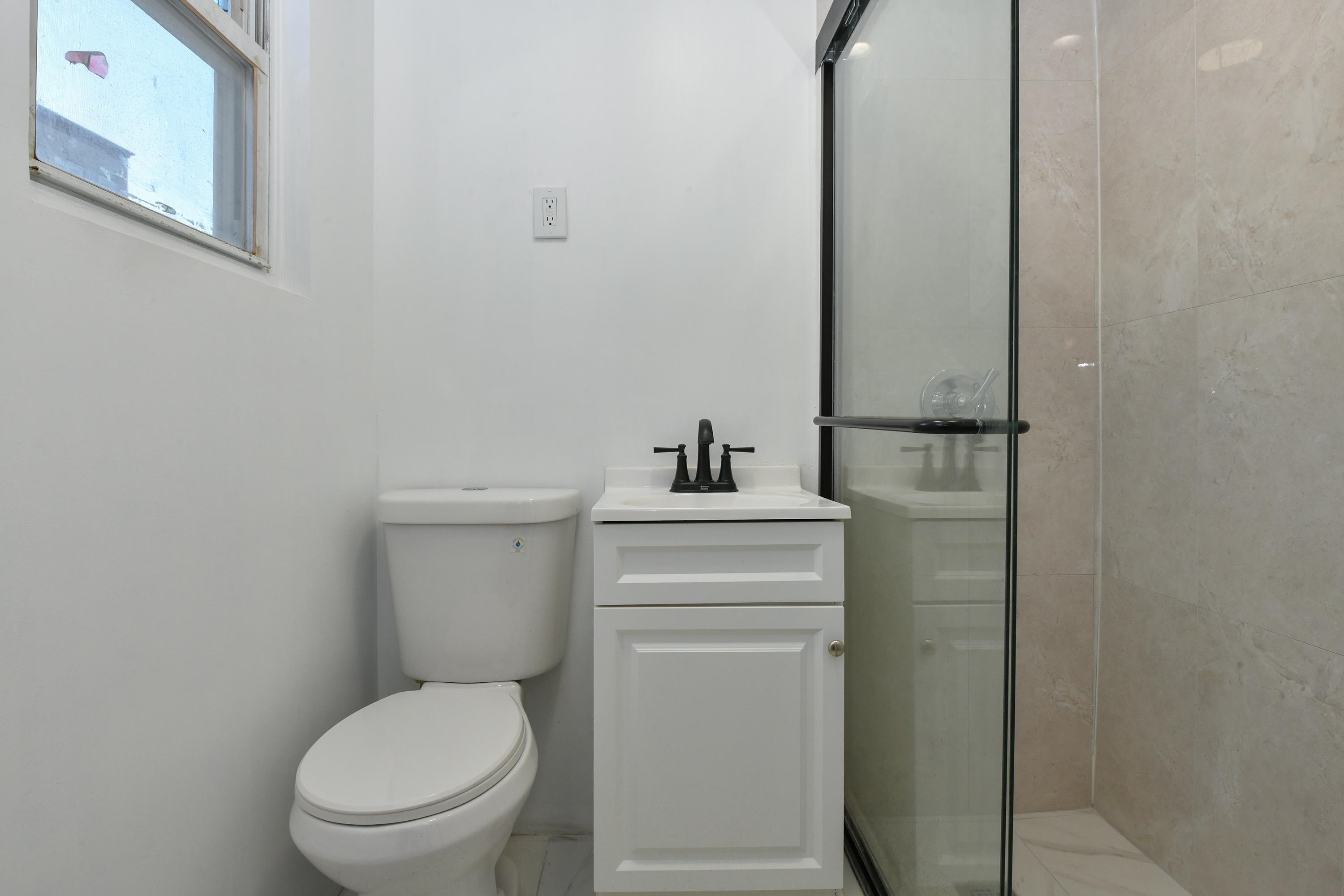 531 28th Street, Unit 2 Union City, NJ 07087 - Photo 2 of 25 a bathroom with a toilet a sink and mirror