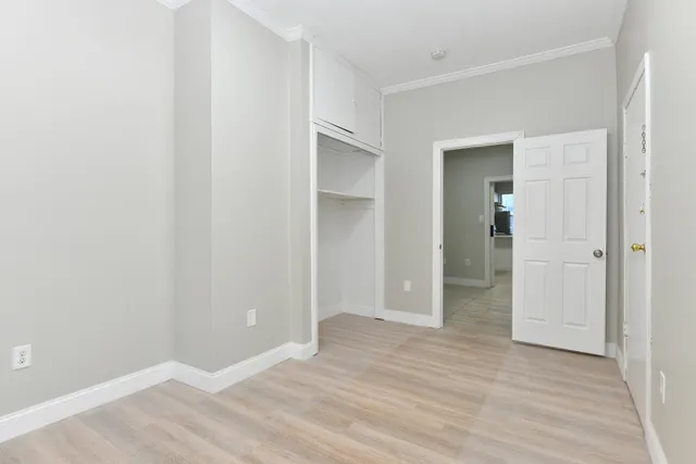 a view of an empty room with wooden floor