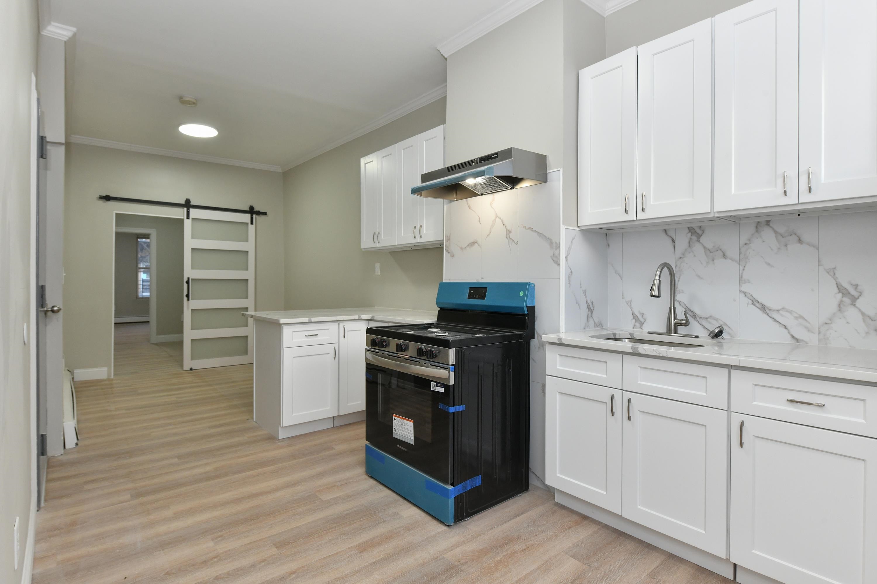 531 28th Street, Unit 2 Union City, NJ 07087 - Photo 4 of 25 a kitchen with a stove and a sink