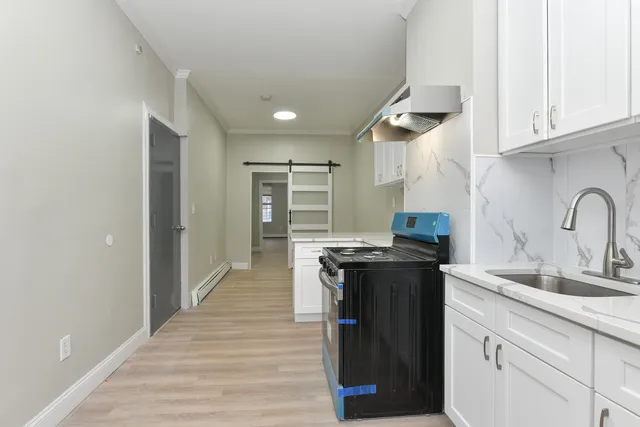 a kitchen with stainless steel appliances granite countertop a stove and a sink