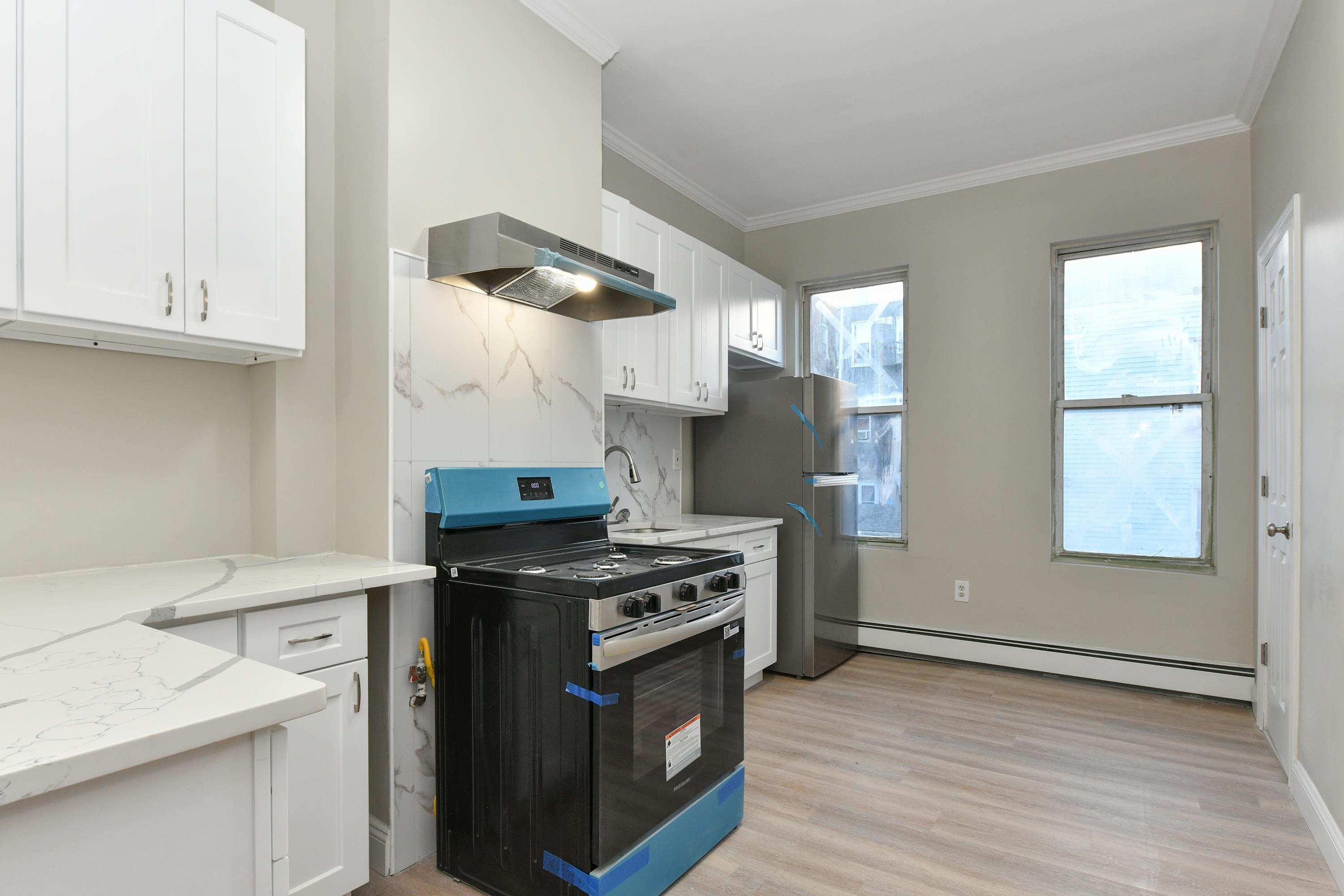 531 28th Street, Unit 2 Union City, NJ 07087 - Photo 7 of 25 a kitchen with a stove and a sink