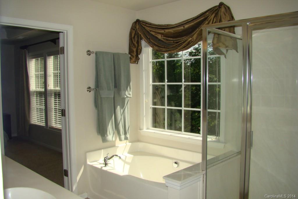 2204 Coltsgate Road Waxhaw, NC 28173 - Photo 11 of 15 a bathroom with a tub and shower