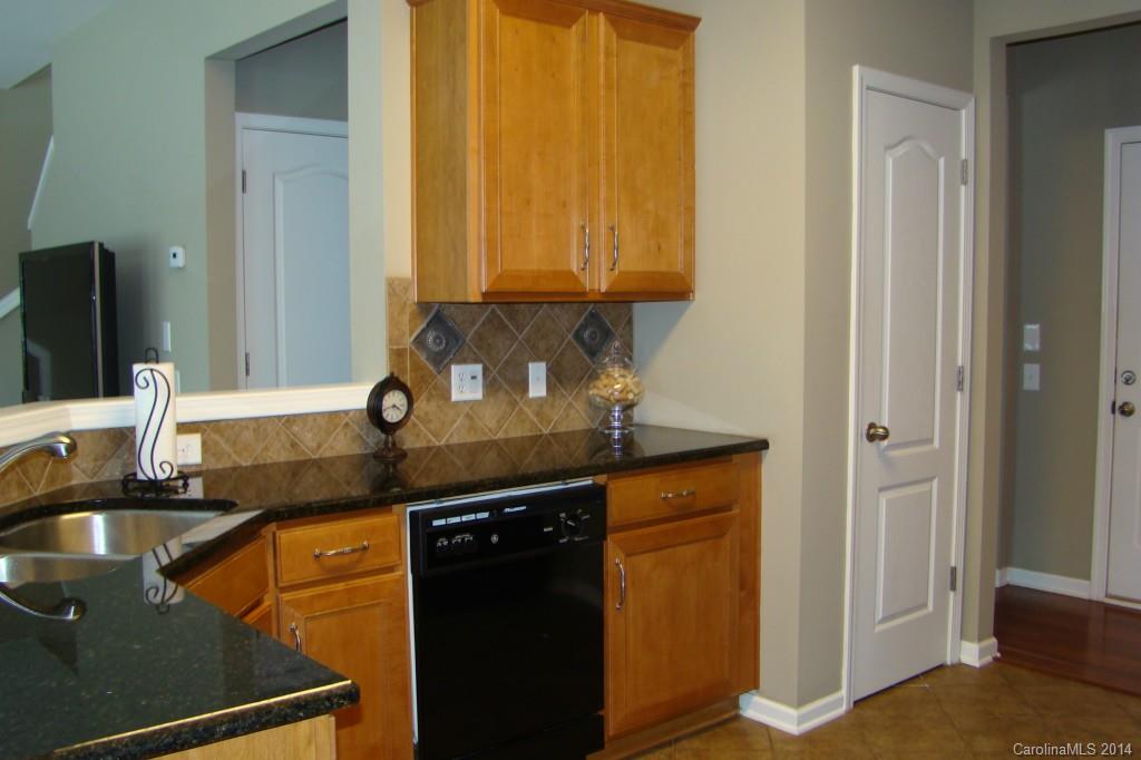 2204 Coltsgate Road Waxhaw, NC 28173 - Photo 6 of 15 a kitchen with granite countertop a sink and a stove top oven